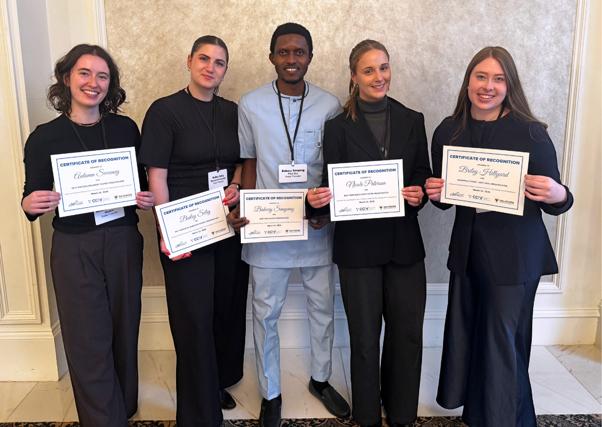 The presentation award winners stand together holding their certificates
